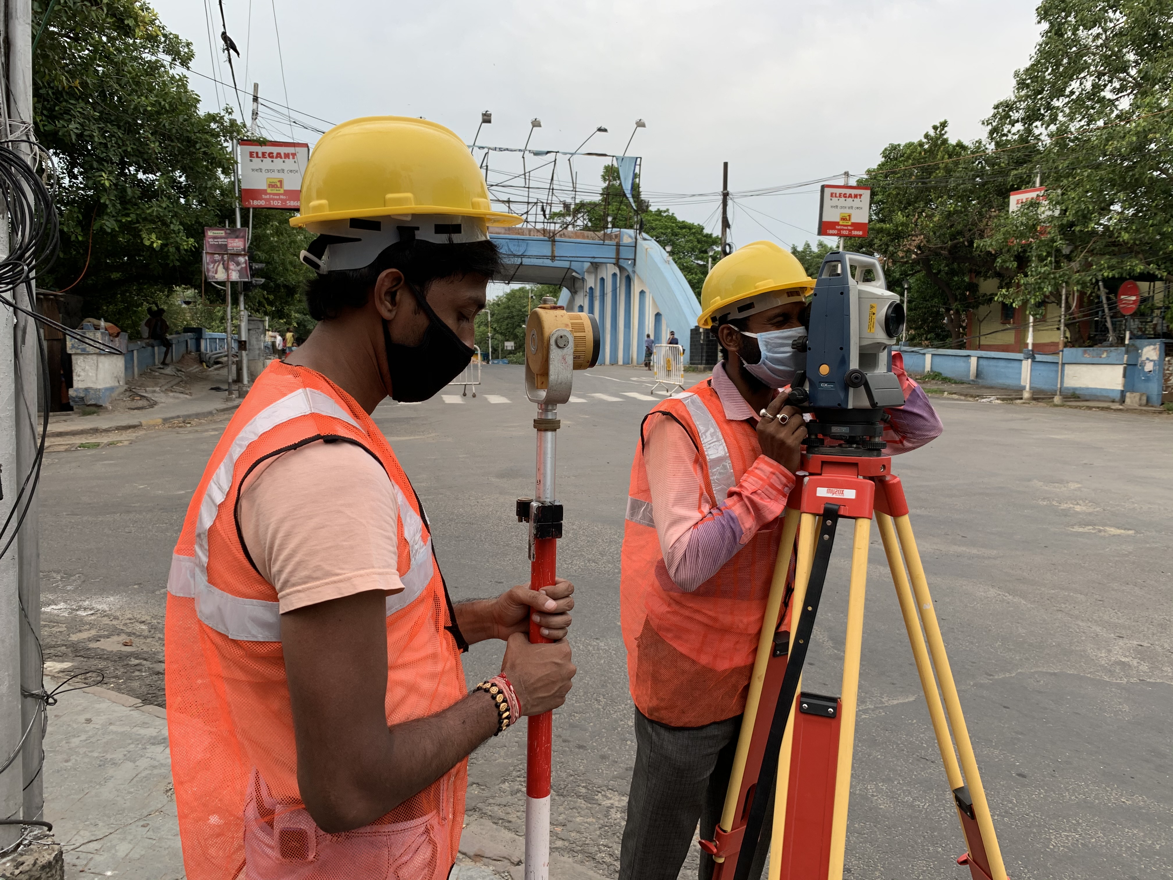 Surveyor using total station for infrastructure route survey